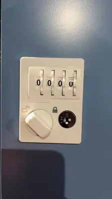 a white electrical outlet on a blue wall at Hotel Adonis Tokyo - Dormitory Share Room For Male Only At City Center in Tokyo