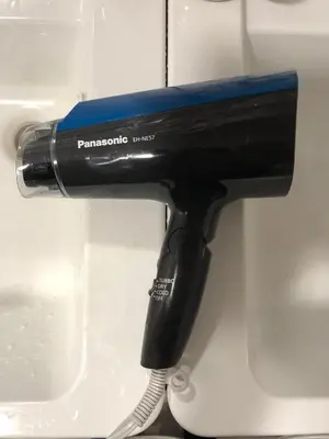 a hair dryer sitting on top of a counter at Hotel Adonis Tokyo - Dormitory Share Room For Male Only At City Center in Tokyo
