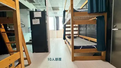 a room with several bunk beds in a building at Hotel Adonis Tokyo - Dormitory Share Room For Male Only At City Center in Tokyo