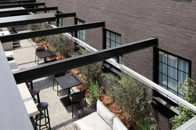 a balcony with a table and chairs and a building at HOTEL CEN in Tokyo