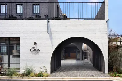 a white brick building with an archway at HOTEL CEN in Tokyo