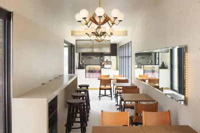 a restaurant with a bar and tables and chairs at HOTEL CEN in Tokyo