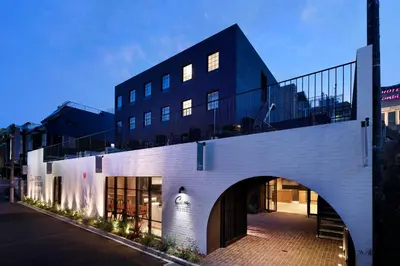 a white brick building with an archway in front of it at HOTEL CEN in Tokyo