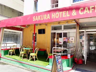 a sauna hotel and cafe with tables and chairs at Sakura Hotel Jimbocho in Tokyo