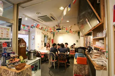 a group of people sitting at a table in a restaurant at Sakura Hotel Jimbocho in Tokyo
