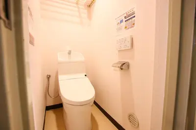 a bathroom with a white toilet in a stall at Sakura Hotel Jimbocho in Tokyo