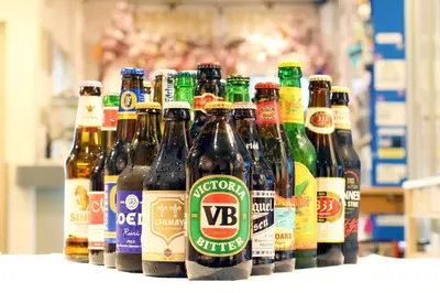 a row of bottles of beer sitting on a shelf at Sakura Hotel Jimbocho in Tokyo