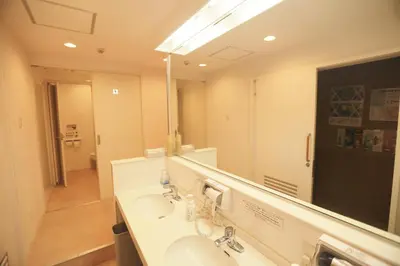 a bathroom with a sink and a large mirror at Sakura Hotel Jimbocho in Tokyo