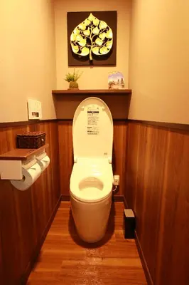 a bathroom with a toilet with a picture on the wall at Hotel Balian Resort Higashi Shinjuku in Tokyo