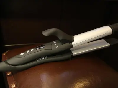 a black and white remote control sitting on a table at Hotel Balian Resort Higashi Shinjuku in Tokyo