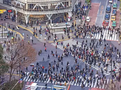 a crowd of people crossing a street in a city at Ginza Creston in Tokyo