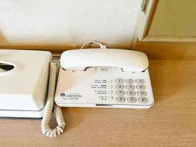 a white phone sitting on top of a table at Ginza Creston in Tokyo