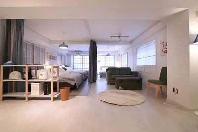a bedroom with a bed and a living room at Spacious Tokyo Apartment for 6-8 Guests!! 1 min to Morisita Station , Direct to Shinjuku in Tokyo