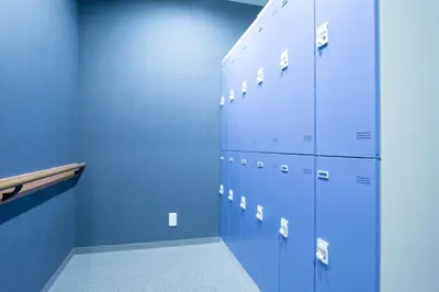 a row of blue lockers in a blue room at Playsis Asakusa in Tokyo
