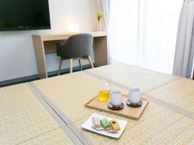 a hotel room with a tray of food and a glass of orange juice at Playsis Asakusa in Tokyo