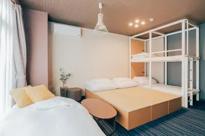a room with two beds and a bunk bed at Playsis Asakusa in Tokyo