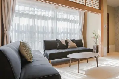 a living room with a couch and a table at Playsis Asakusa in Tokyo