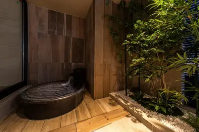 a room with a bath tub and some plants at HOTEL AMANEK Kamata-Eki Mae in Tokyo