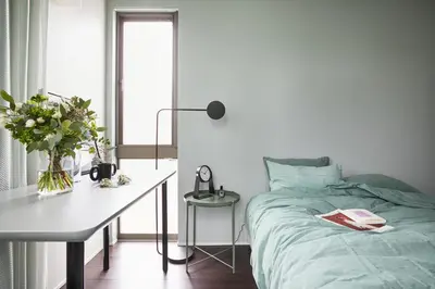 a bedroom with a bed and a desk with a vase of flowers at P O IN T - 3BR Villa - Ikebukuro in Tokyo