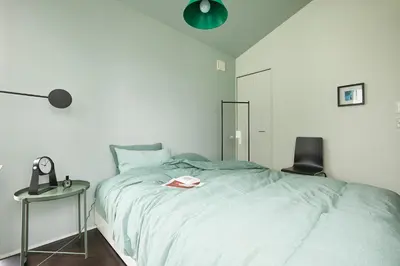 a bedroom with a bed with a book on it at P O IN T - 3BR Villa - Ikebukuro in Tokyo