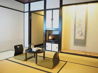 a living room with a table and chairs and a television at The Edo Sakura in Tokyo