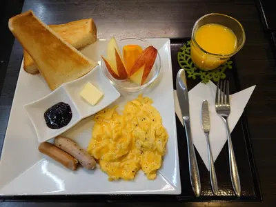 a plate of breakfast food with eggs sausage bread and toast at The Edo Sakura in Tokyo