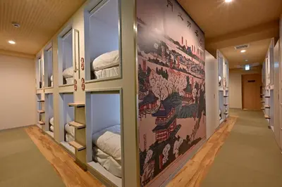 a hallway with a wall with a map of the world at Hotel Tomariya Ueno in Tokyo