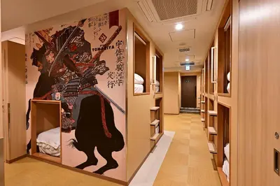 a hallway with a wall with a painting of a samurai at Hotel Tomariya Ueno in Tokyo
