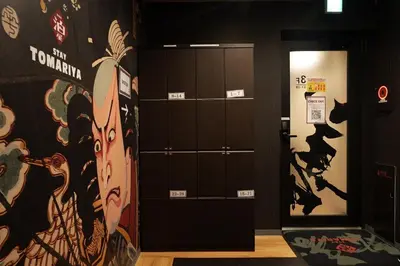 a room with brown lockers and a painting on the wall at Hotel Tomariya Ueno in Tokyo