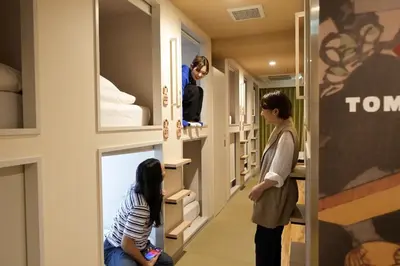 a woman and a girl in a room with bunk beds at Hotel Tomariya Ueno in Tokyo