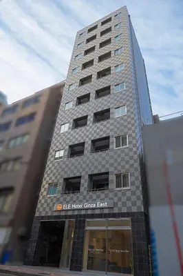 a tall building with a sign on it at ELE Hotel Ginza East in Tokyo
