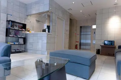 a living room with a couch and a glass table at ELE Hotel Ginza East in Tokyo