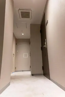 an empty hallway with an open door in a building at ELE Hotel Ginza East in Tokyo