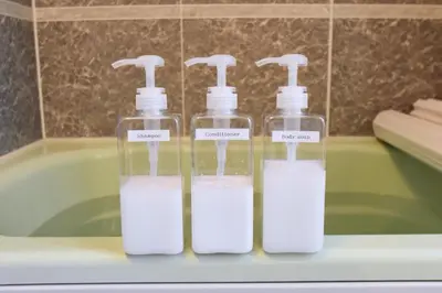 three bottles of soap sitting on top of a bath tub at TERRACE HOUSE Shibuya Maruyamacho in Tokyo