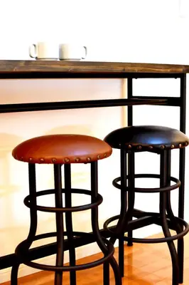 two bar stools sitting in front of a counter at TERRACE HOUSE Shibuya Maruyamacho in Tokyo