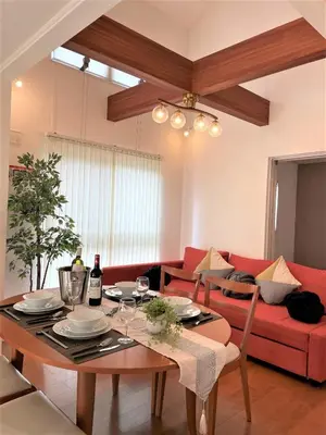 a living room with a table and a red couch at Skytree House In Tokyo in Tokyo