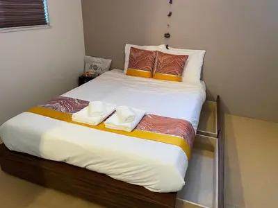 a bed with two towels on top of it at Skytree House In Tokyo in Tokyo