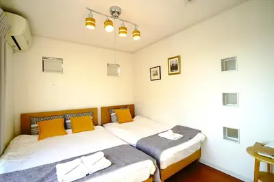 a bedroom with two beds and a tv at Skytree House In Tokyo in Tokyo