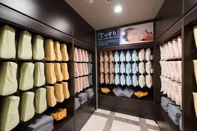a walk in closet with lots of shirts and ties at Super Hotel Premier Tokyo Station Yaesu-Chuoguchi in Tokyo