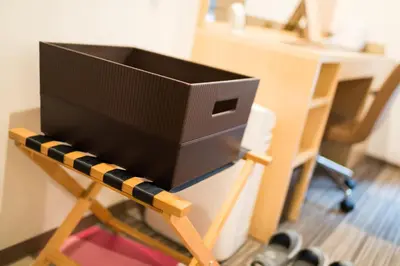 a computer monitor sitting on top of a wooden stand at Super Hotel Premier Tokyo Station Yaesu-Chuoguchi in Tokyo