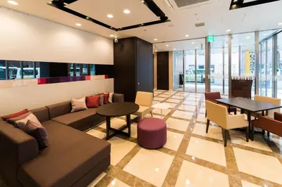 a lobby of a building with a couch and a table at Super Hotel Premier Tokyo Station Yaesu-Chuoguchi in Tokyo