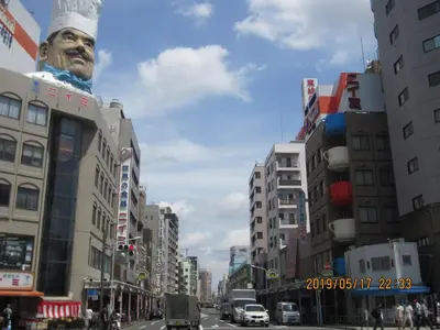 a city street with a large statue of a man at Asakusa HomeSuites Tokyo in Tokyo