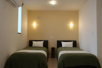 two beds sitting next to each other in a room at Asakusa HomeSuites Tokyo in Tokyo