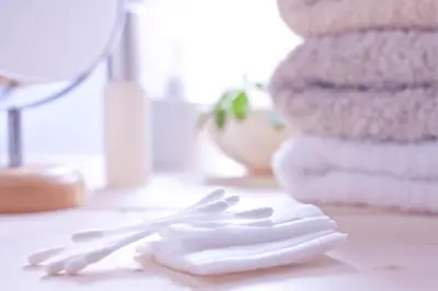 two white plastic utensils sitting on a counter with towels at Asakusa HomeSuites Tokyo in Tokyo