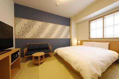 a bedroom with a large bed and a television at Onyado Nono Asakusa Natural Hot Spring in Tokyo