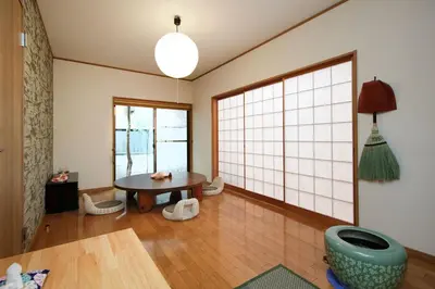 a living room with a table and a large window at Ryokan ASAKUSA-chaka- by Tranova in Tokyo