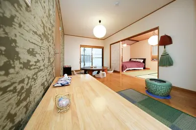 a living room with a table and a bedroom at Ryokan ASAKUSA-chaka- by Tranova in Tokyo