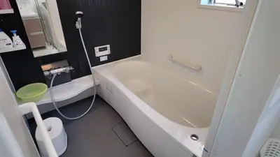 a bathroom with a white tub and a toilet at First sight hut house in Tokyo