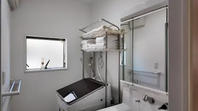 a bathroom with a mirror and a sink at First sight hut house in Tokyo