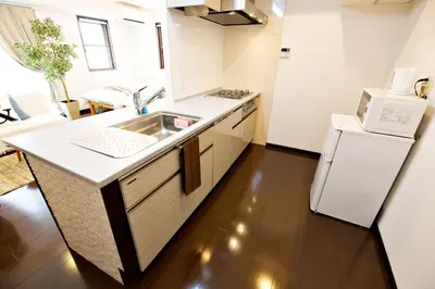 a kitchen with a sink and a refrigerator at Kanbe Building 301 in Tokyo